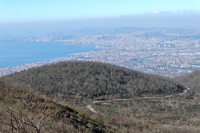 High angle view of city by sea against sky