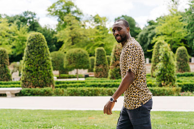 Positive afro american stylish man in european city