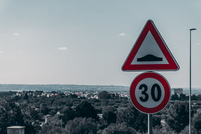 Low angle view of road sign against sky