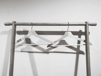 Close-up of clothes hanging on railing against sky