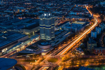 High angle view of illuminated city street and buildings at night