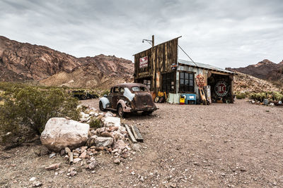 Abandoned car on mountain against sky