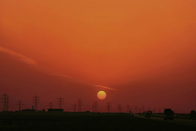 Scenic view of silhouette landscape against orange sky