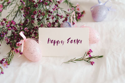 Easter eggs with flowers on white linen fabric.