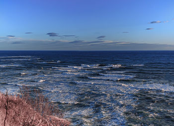 Scenic view of sea against blue sky