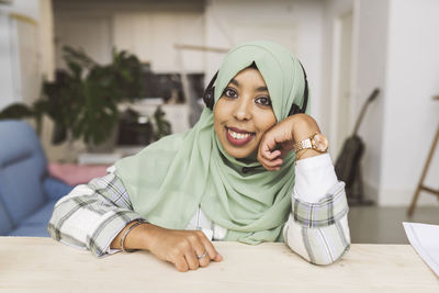 Smiling woman sitting at table