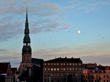 View of buildings in city at sunset