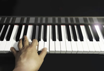 Close-up of hands playing piano