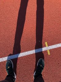 Low section of person standing on running track