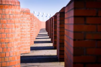 View of staircase against brick wall