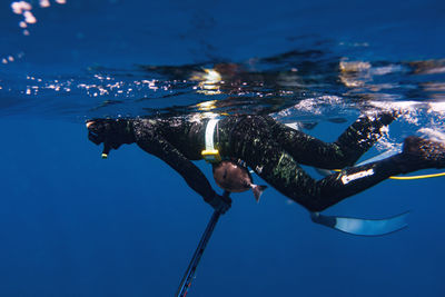 Low section of woman swimming in sea