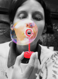 Close-up portrait of a woman holding bubbles