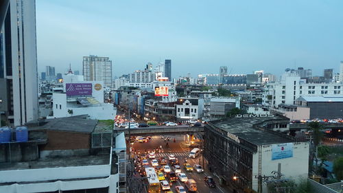 High angle view of illuminated city buildings against sky