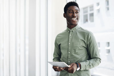 Portrait of smiling young man standing outdoors