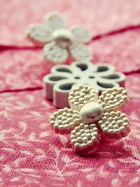 Close-up of buttons on pink fabric