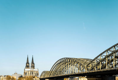 Low angle view of bridge against clear blue sky