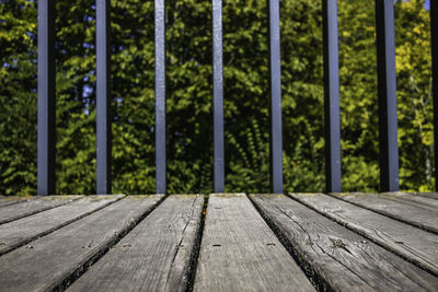 Close up of wooden walkway with metal railings background