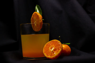 Orange slice in glass on table