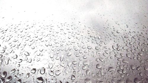 Raindrops on glass window during rainy season