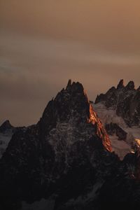 Rock formation on land against sky during sunset