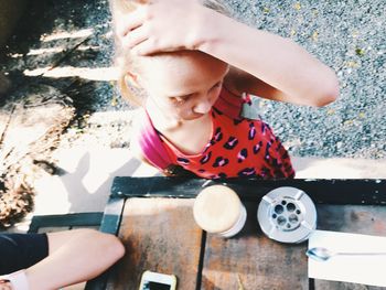 High angle view of cute boy holding table