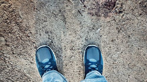 Low section of person standing on tiled floor