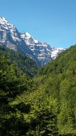 Scenic view of snowcapped mountains against clear sky