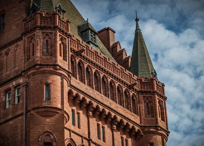 Majestic old building against cloudy sky