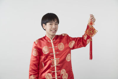 Smiling boy standing against white background