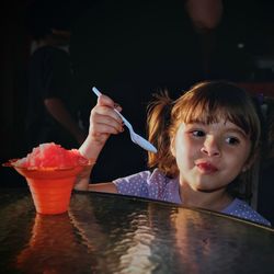 Girl having shave ice at table