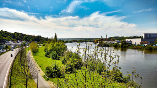 Scenic view of river against cloudy sky