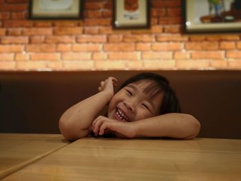 Portrait of smiling girl at table