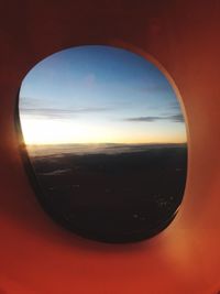 Scenic view of sunset seen through airplane window