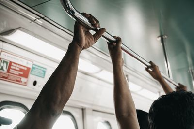 Low angle view of man working on metal