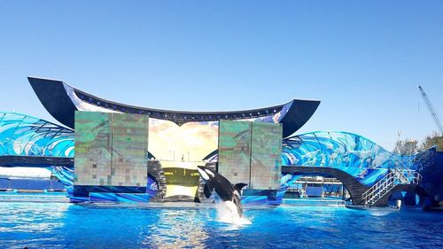 Swimming pool against clear blue sky