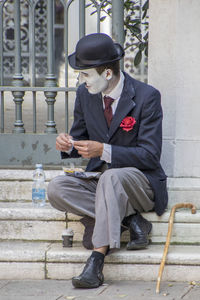 Full length of man sitting on seat