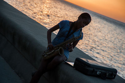 Man playing guitar on beach