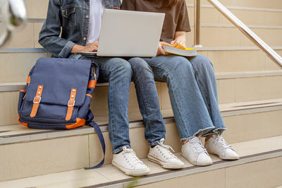 Low section of people sitting on seat