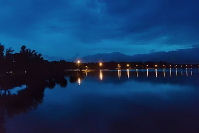 Scenic view of lake against sky at night