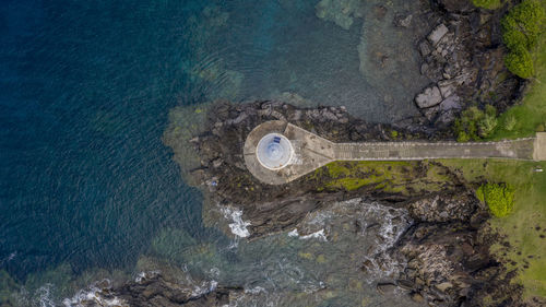 High angle view of rock by sea