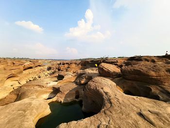 Rock formations on landscape against sky
