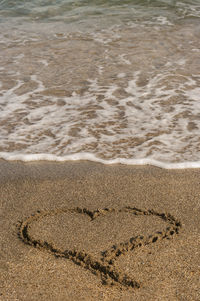 High angle view of heart shape on sandy beach