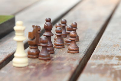 Close-up of chess pieces on wooden table