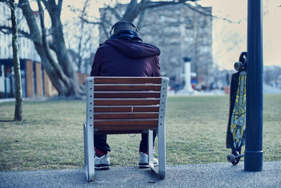 Rear view of woman sitting outdoors