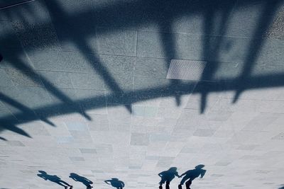 Shadow of people walking on street