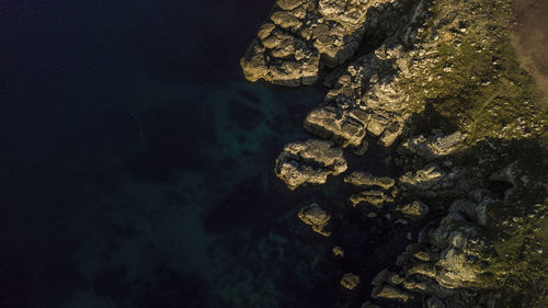 Aerial view of rocky shore during sunset
