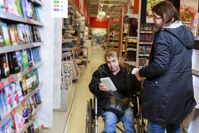 Female carer helping woman with shopping