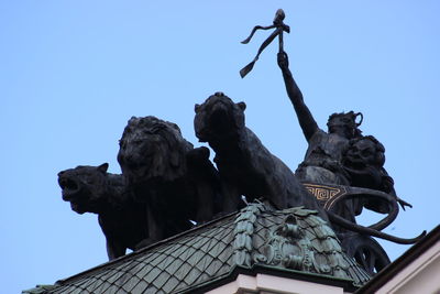 Low angle view of sculptures against clear sky