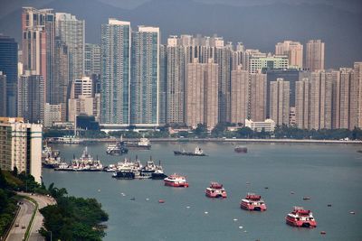 High angle view of buildings by sea in city