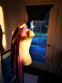 Rear view of woman looking through window